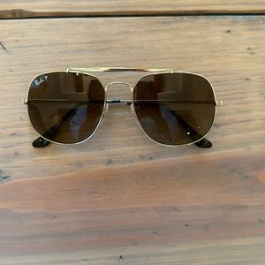 Brand new Ray Ban sunglasses. Never worn. Not damaged. Gold frame. Very cute!